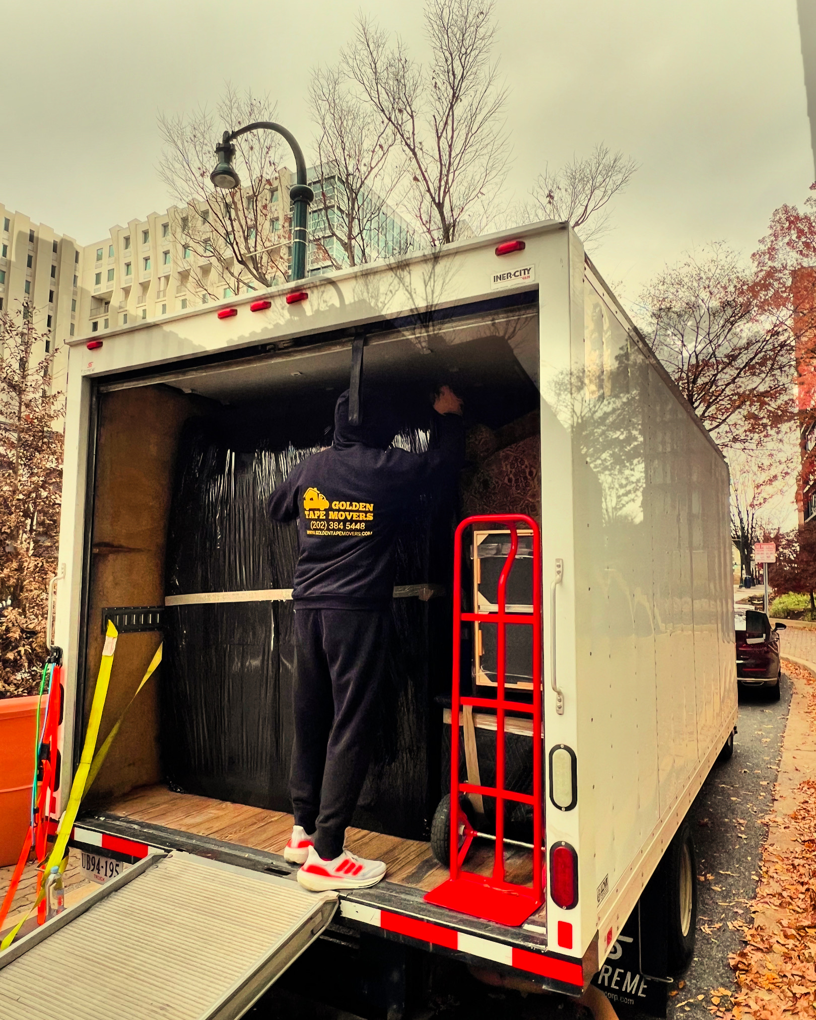 residential-moving-arlington-va Professional movers in Arlington, VA, carefully relocating household items into a high-rise apartment or suburban home.
